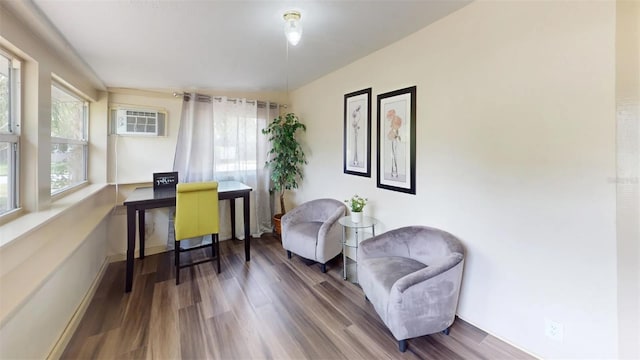 office with a wall mounted air conditioner and hardwood / wood-style flooring