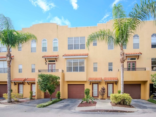 view of front facade featuring a balcony and a garage