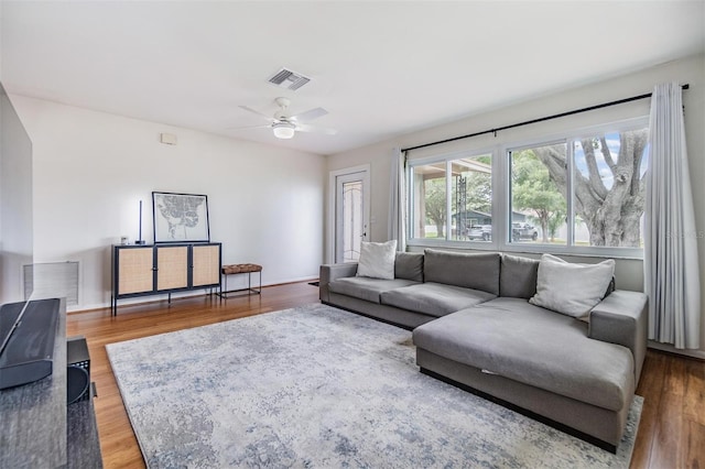 living room with ceiling fan and wood-type flooring