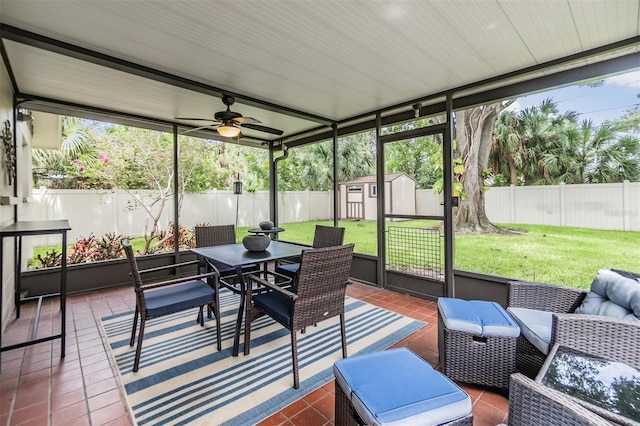 sunroom / solarium featuring ceiling fan