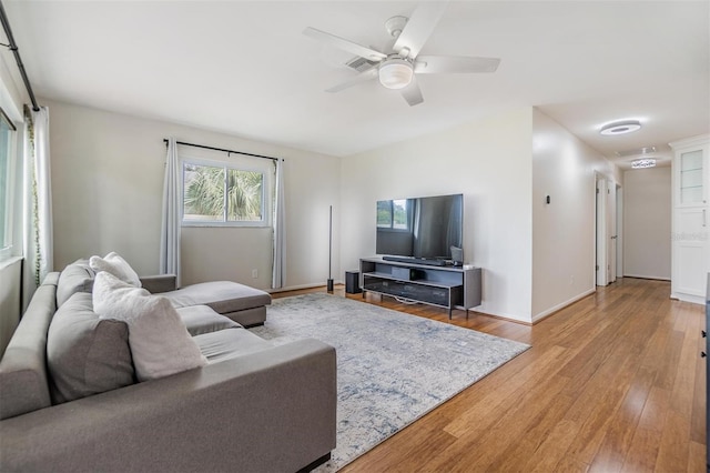 living room featuring hardwood / wood-style floors and ceiling fan