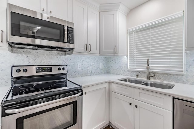 kitchen featuring white cabinetry, backsplash, stainless steel appliances, and sink