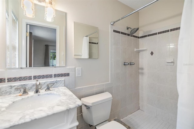 bathroom featuring vanity, toilet, a shower with curtain, and tile walls