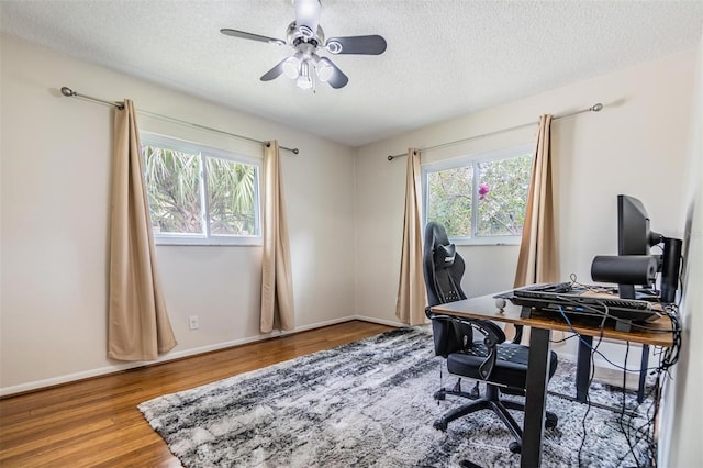 office area featuring hardwood / wood-style floors, ceiling fan, and a textured ceiling