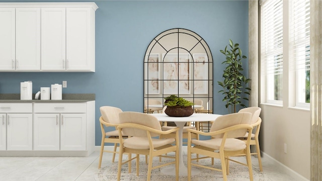 dining space with light tile patterned floors and baseboards