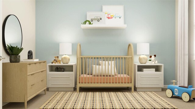 carpeted bedroom featuring a nursery area