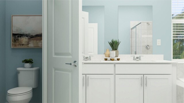 bathroom with a shower with door, vanity, and toilet