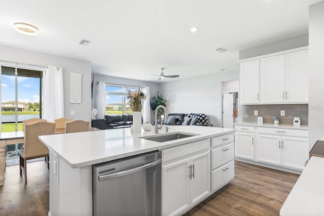 kitchen with a healthy amount of sunlight, white cabinetry, dishwasher, and sink