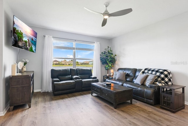 living room featuring ceiling fan and hardwood / wood-style floors