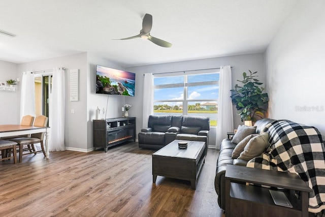 living room featuring ceiling fan and hardwood / wood-style flooring