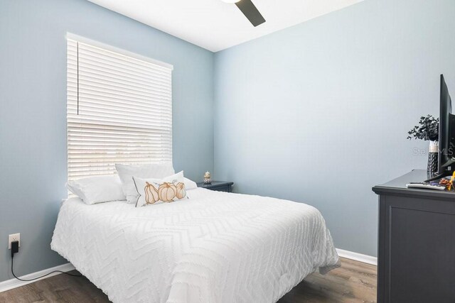 bedroom featuring ceiling fan and dark hardwood / wood-style flooring