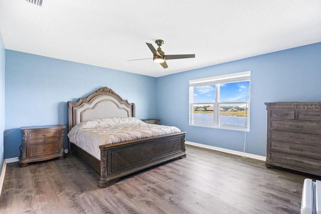 bedroom featuring ceiling fan and dark wood-type flooring