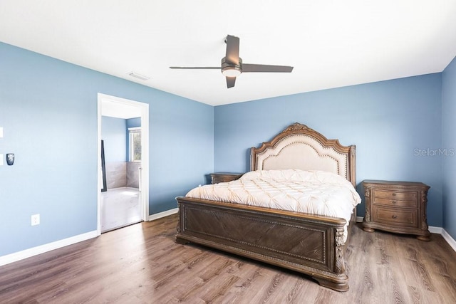 bedroom with connected bathroom, ceiling fan, and hardwood / wood-style flooring