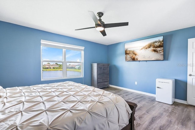 bedroom with ceiling fan and hardwood / wood-style flooring