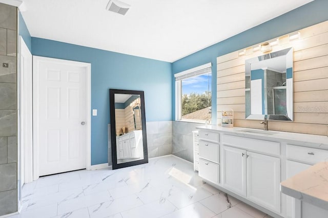 bathroom featuring walk in shower and vanity