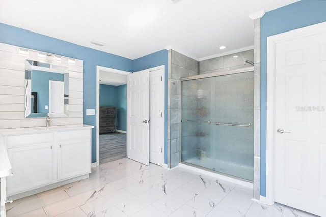 bathroom featuring vanity and an enclosed shower