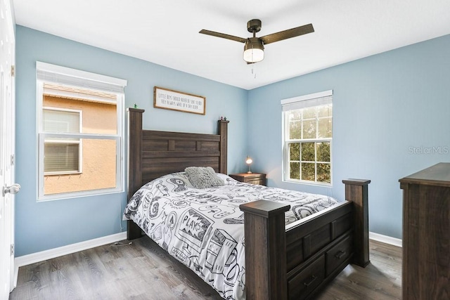 bedroom with ceiling fan and dark wood-type flooring