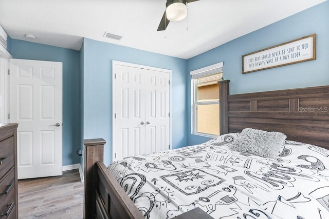 bedroom featuring ceiling fan, a closet, and hardwood / wood-style floors