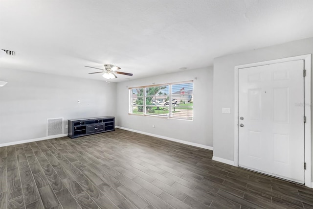 unfurnished living room with dark wood-type flooring and ceiling fan