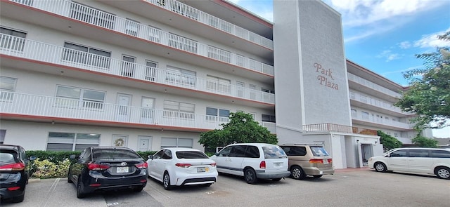 view of building exterior featuring uncovered parking