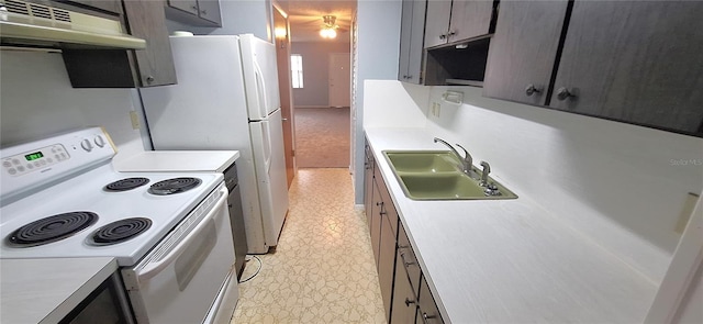 kitchen featuring electric range, under cabinet range hood, a sink, light countertops, and light floors