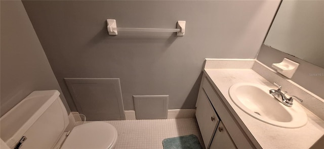 bathroom with vanity, toilet, and tile patterned flooring