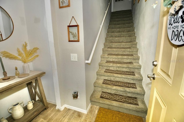 staircase with hardwood / wood-style flooring