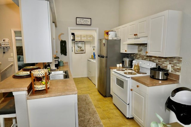 kitchen featuring backsplash, sink, white cabinetry, and white electric range oven