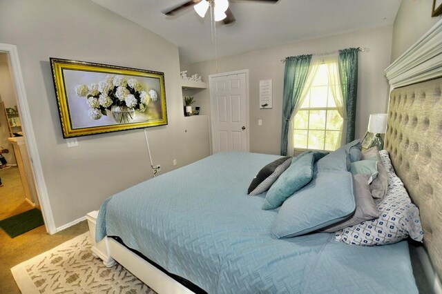 carpeted bedroom featuring ceiling fan and vaulted ceiling