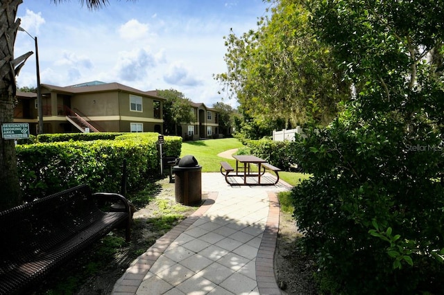 view of community with a patio area and a yard