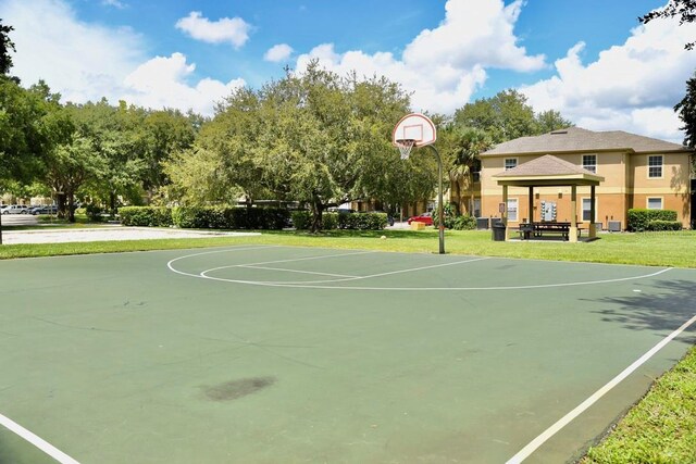 view of basketball court featuring a lawn and a gazebo