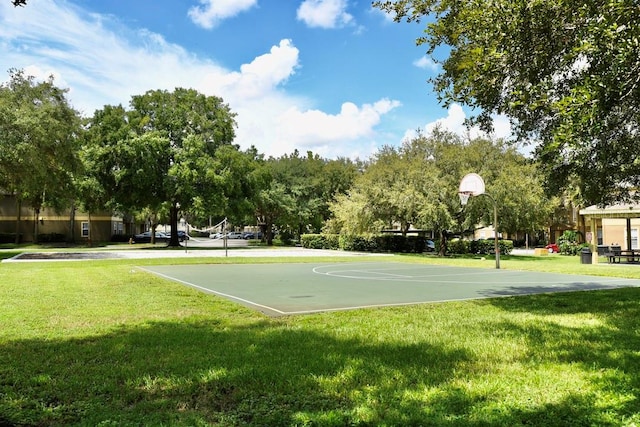 view of sport court featuring a lawn