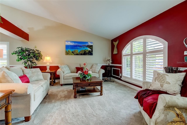 carpeted living room with lofted ceiling