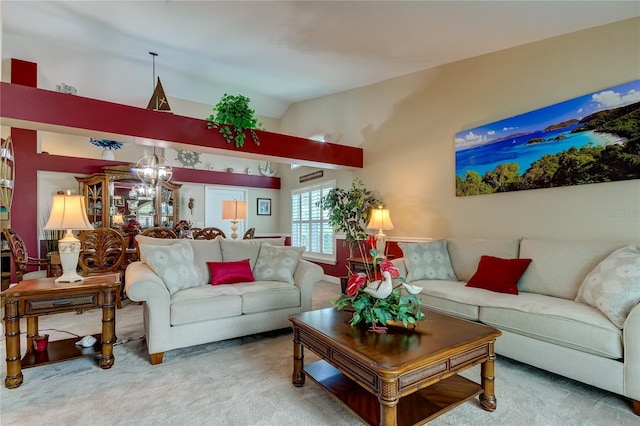 carpeted living area with a notable chandelier and vaulted ceiling