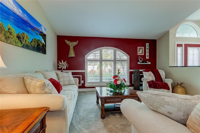 carpeted living area featuring lofted ceiling