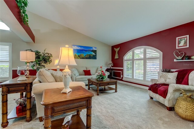 living area with vaulted ceiling and carpet