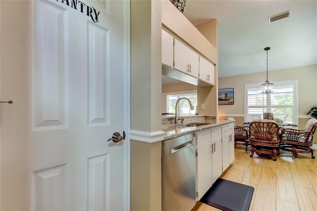 kitchen featuring visible vents, white cabinetry, a sink, dishwasher, and decorative light fixtures