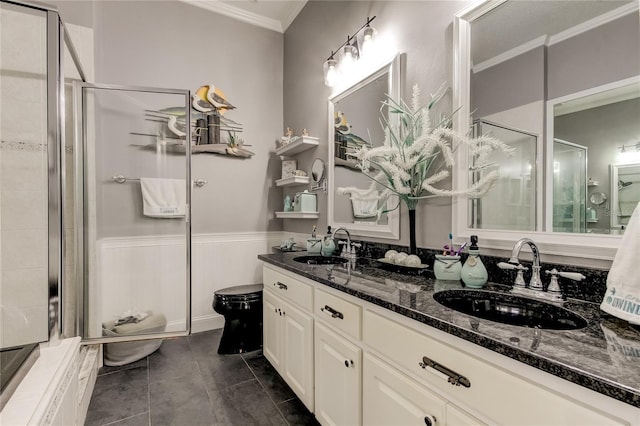 bathroom with a sink, tile patterned floors, a shower stall, and crown molding