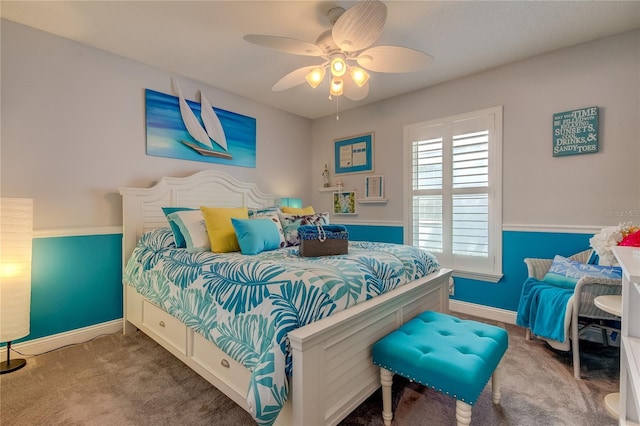 carpeted bedroom featuring baseboards and a ceiling fan