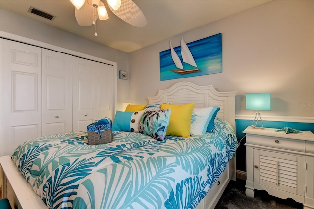 carpeted bedroom with a ceiling fan, visible vents, and a closet