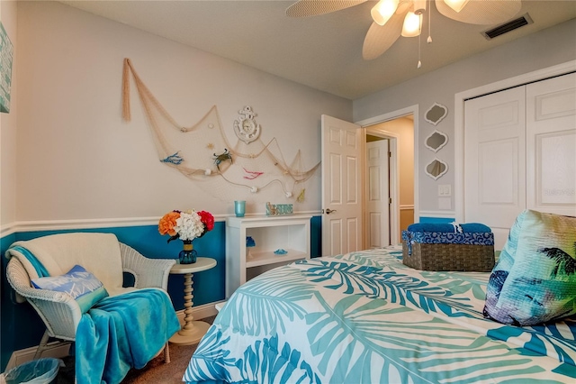 carpeted bedroom with ceiling fan and a closet