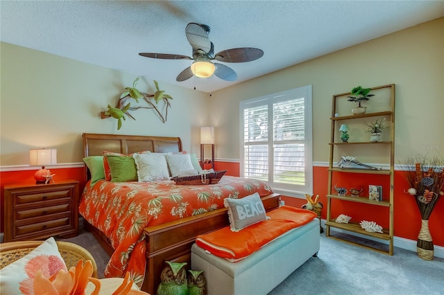 bedroom featuring a textured ceiling, ceiling fan, and carpet floors