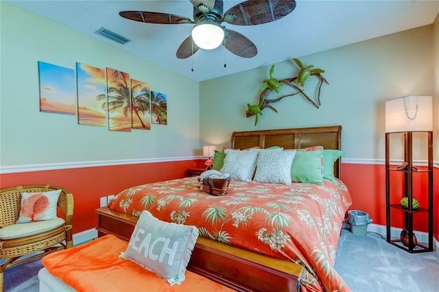 bedroom with visible vents, baseboards, carpet, and ceiling fan