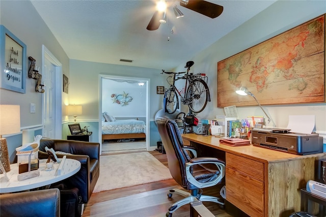 office featuring visible vents, wood finished floors, and a ceiling fan