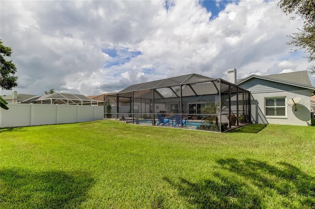 view of yard with a fenced in pool and a lanai