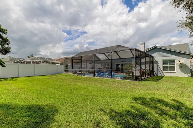 view of yard with glass enclosure, a fenced in pool, and fence