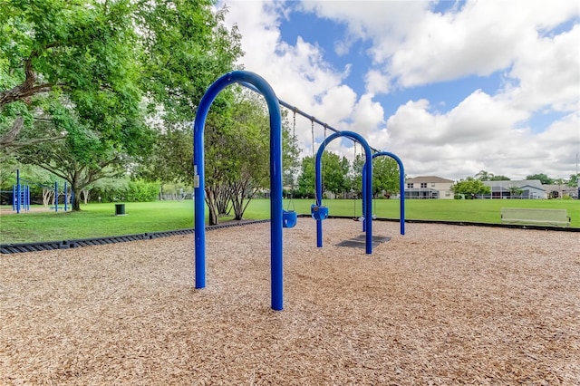 view of home's community with playground community and a lawn