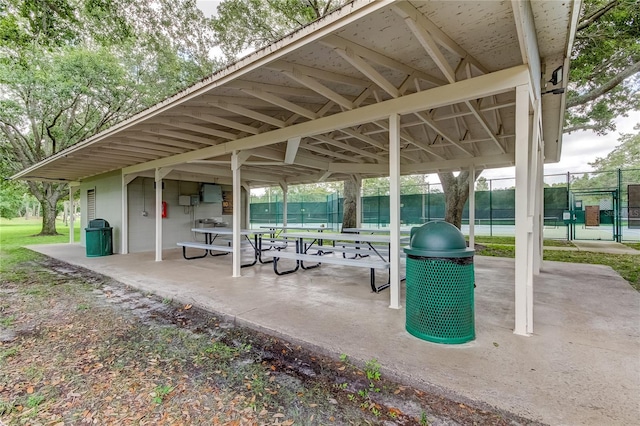 view of home's community featuring fence