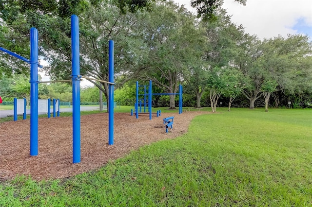 view of home's community featuring playground community and a yard