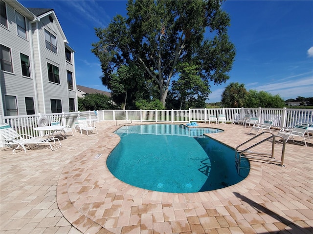 view of swimming pool featuring a patio